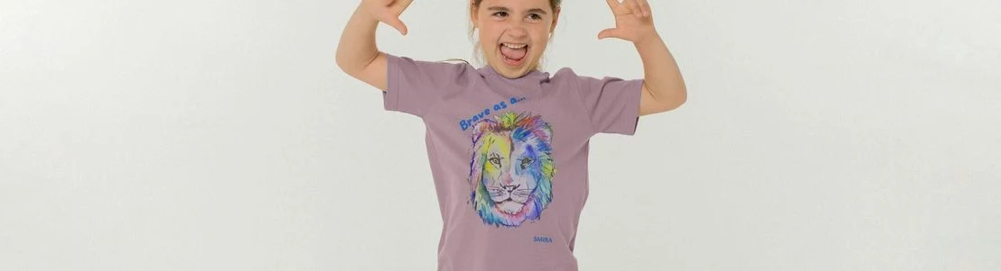 Child wearing 'Brave as a lion' SMIRA t-shirt, with a colourful lion's head.