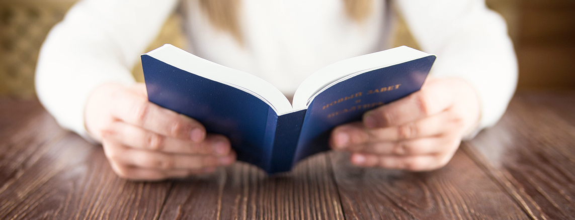 Hands holding a book.
