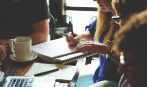 Professionals meeting around a table.