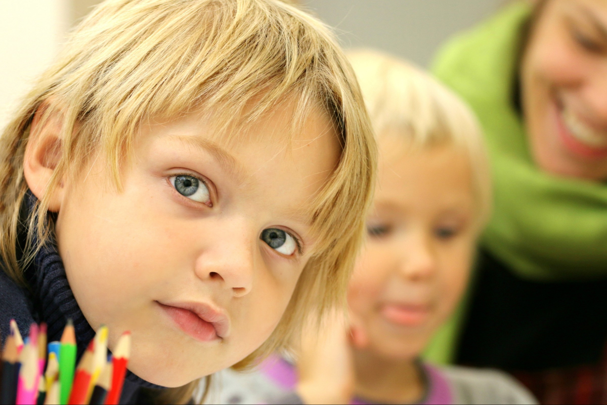 Young children and coloured pencils.