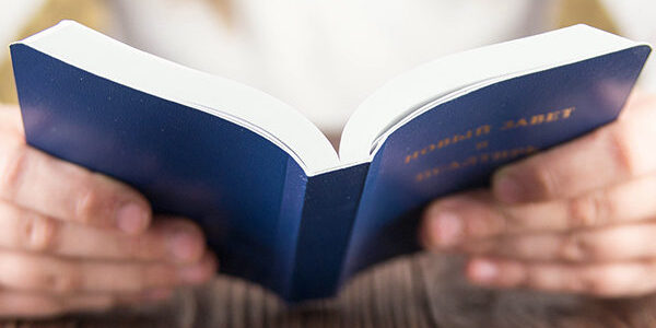Hands holding a book.