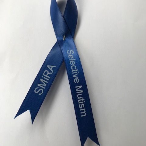 Blue crossed ribbon saying 'SMIRA - Selective Mutism'