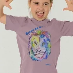 Child wearing 'Brave as a lion' SMIRA t-shirt, with a colourful lion's head.